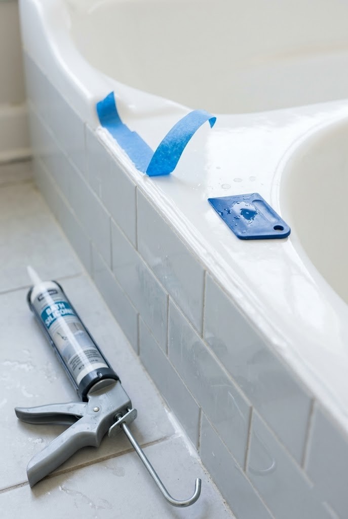 Fresh white caulk line along a rental tub joint