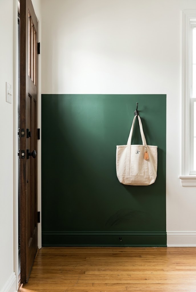 Half-height painted color block behind a front door creating a foyer zone
