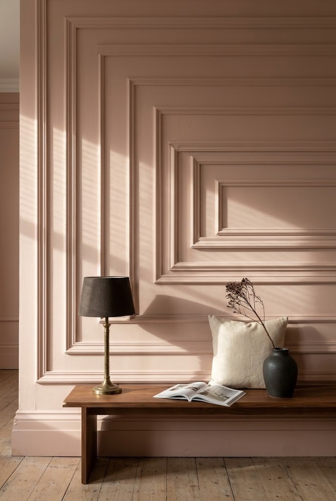 Stepped picture-frame moulding painted clay pink to match the wall behind it