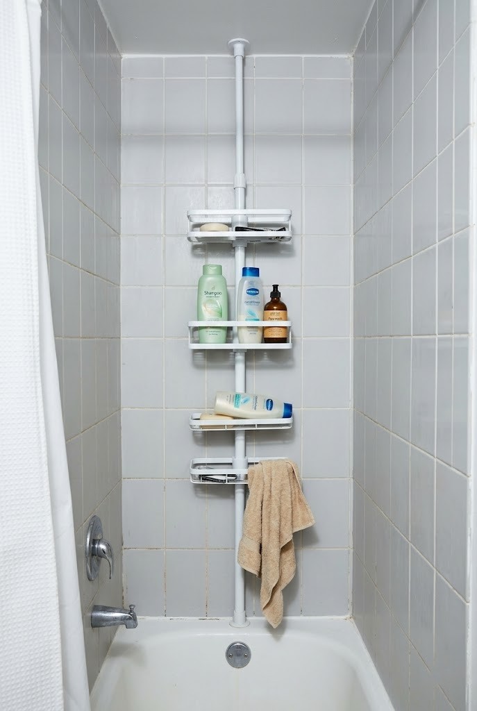 Spring-tension shelf wedged across a rental tub alcove