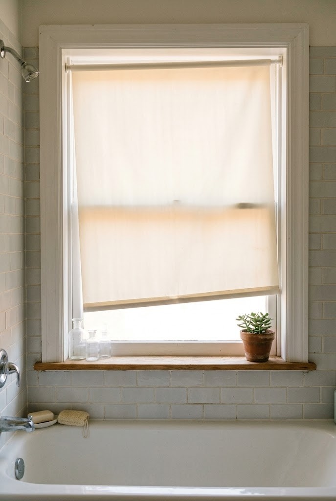 Tension-mounted window shade over a rental tub shower combo