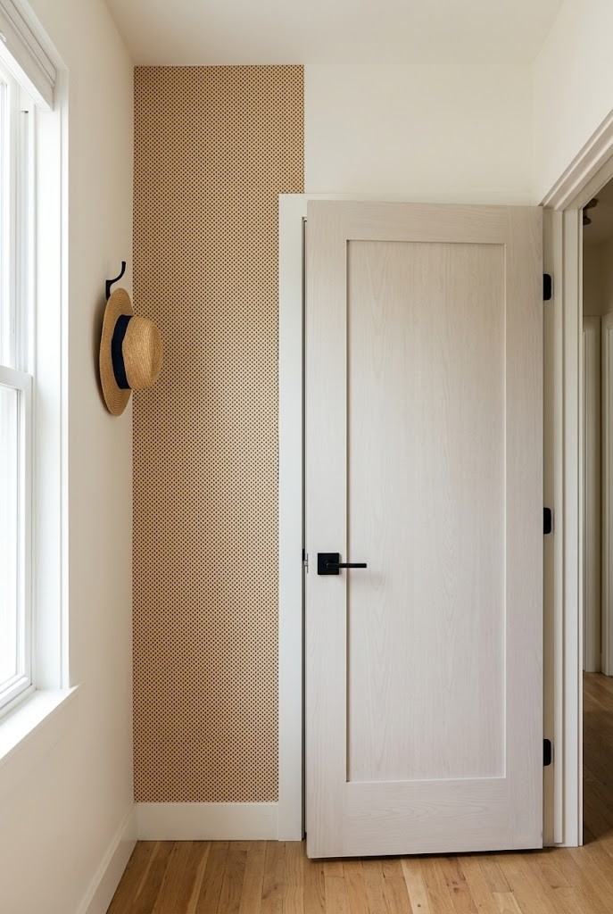 Vertical removable wallpaper panel matching the door width in a living room entry
